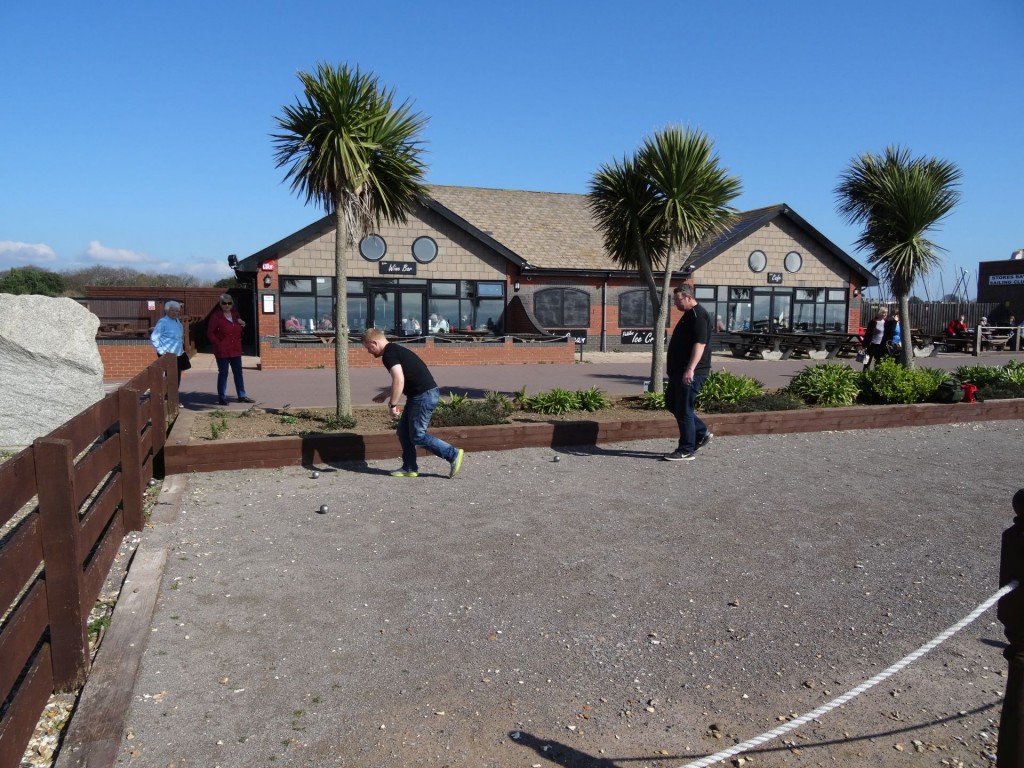 Two members of the Fareham petanque club playing at Stokes Bay