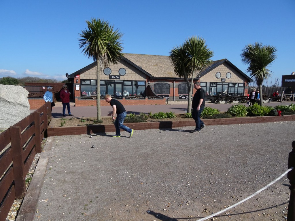 Two members of the Fareham petanque club playing at Stokes Bay